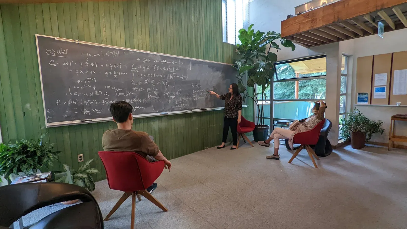 Physicists discussing equations at the chalkboard in Smart Hall at the Aspen Center for Physics